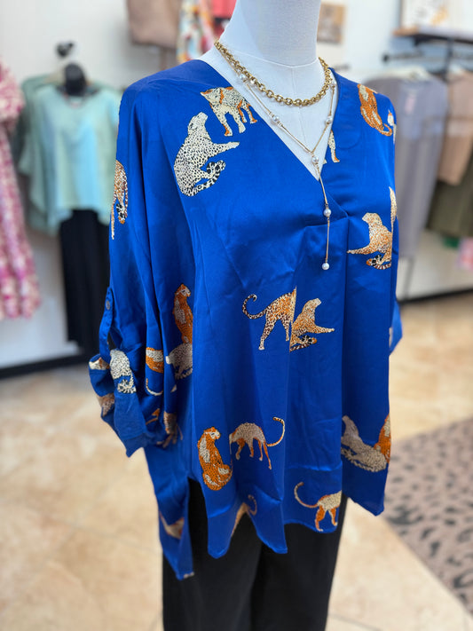 Blue top with animal prints on a mannequin in a store setting
