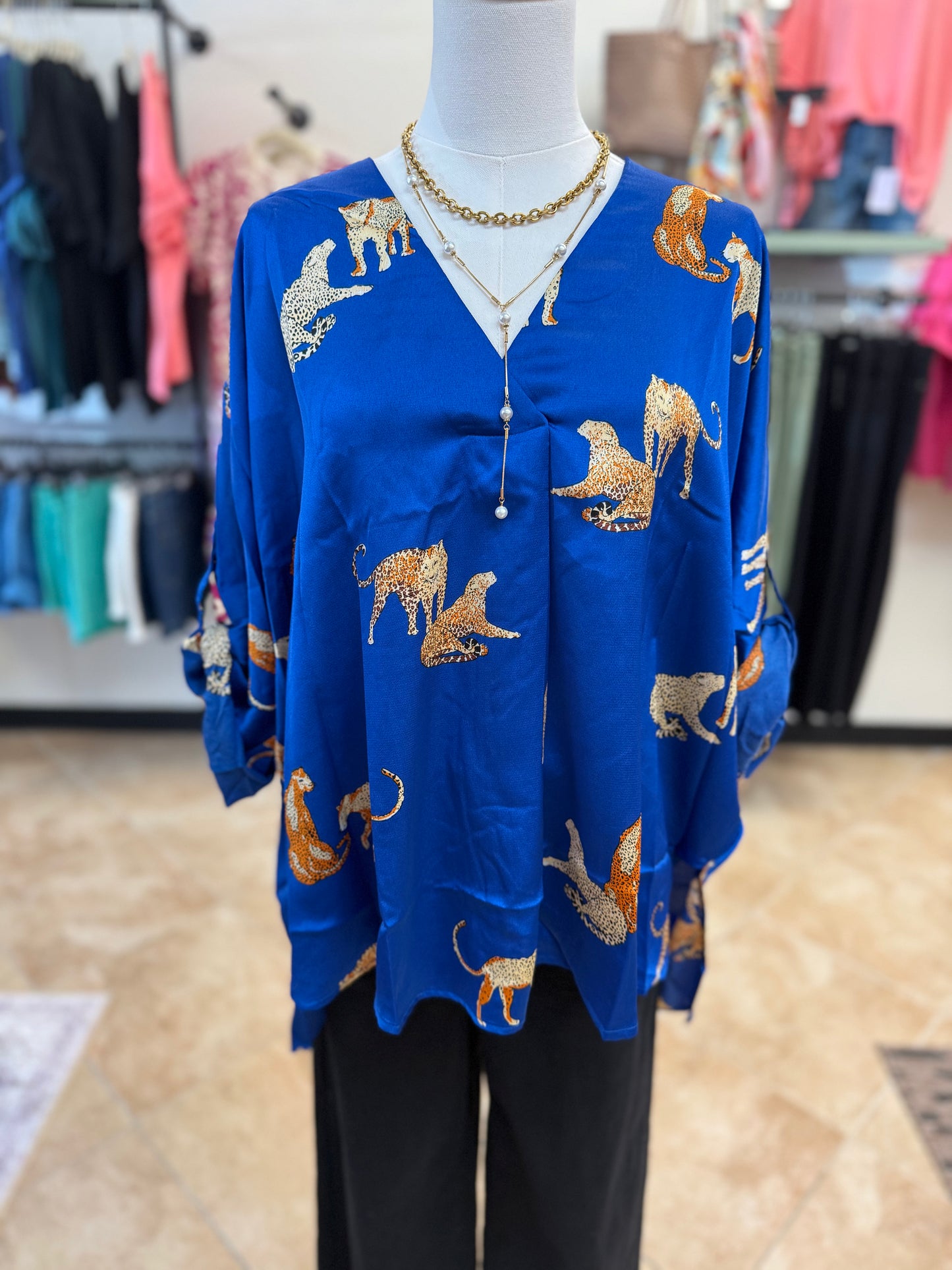 Blue blouse with animal print on a mannequin in a store setting