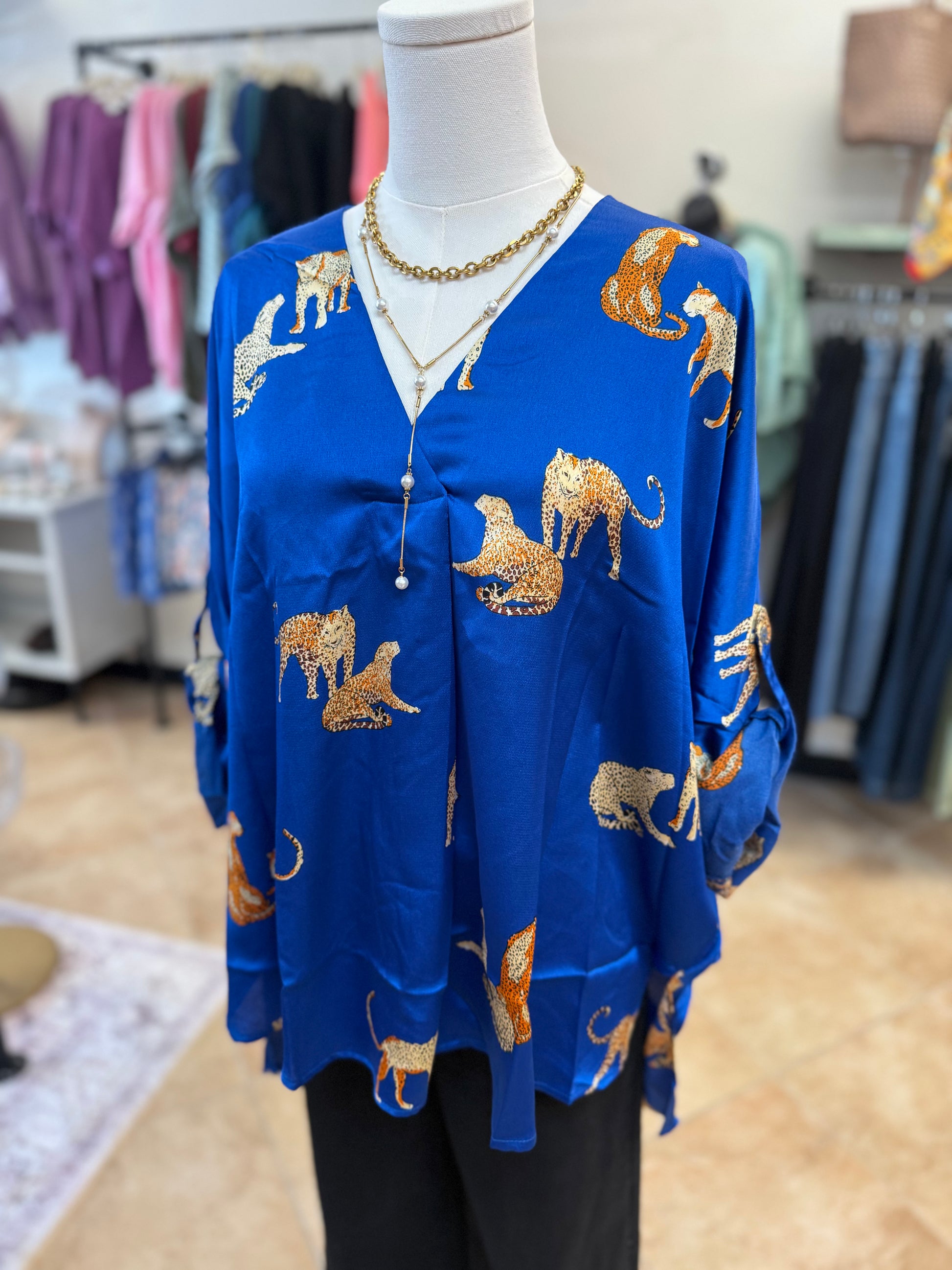 Blue shirt with animal print on a mannequin in a store setting