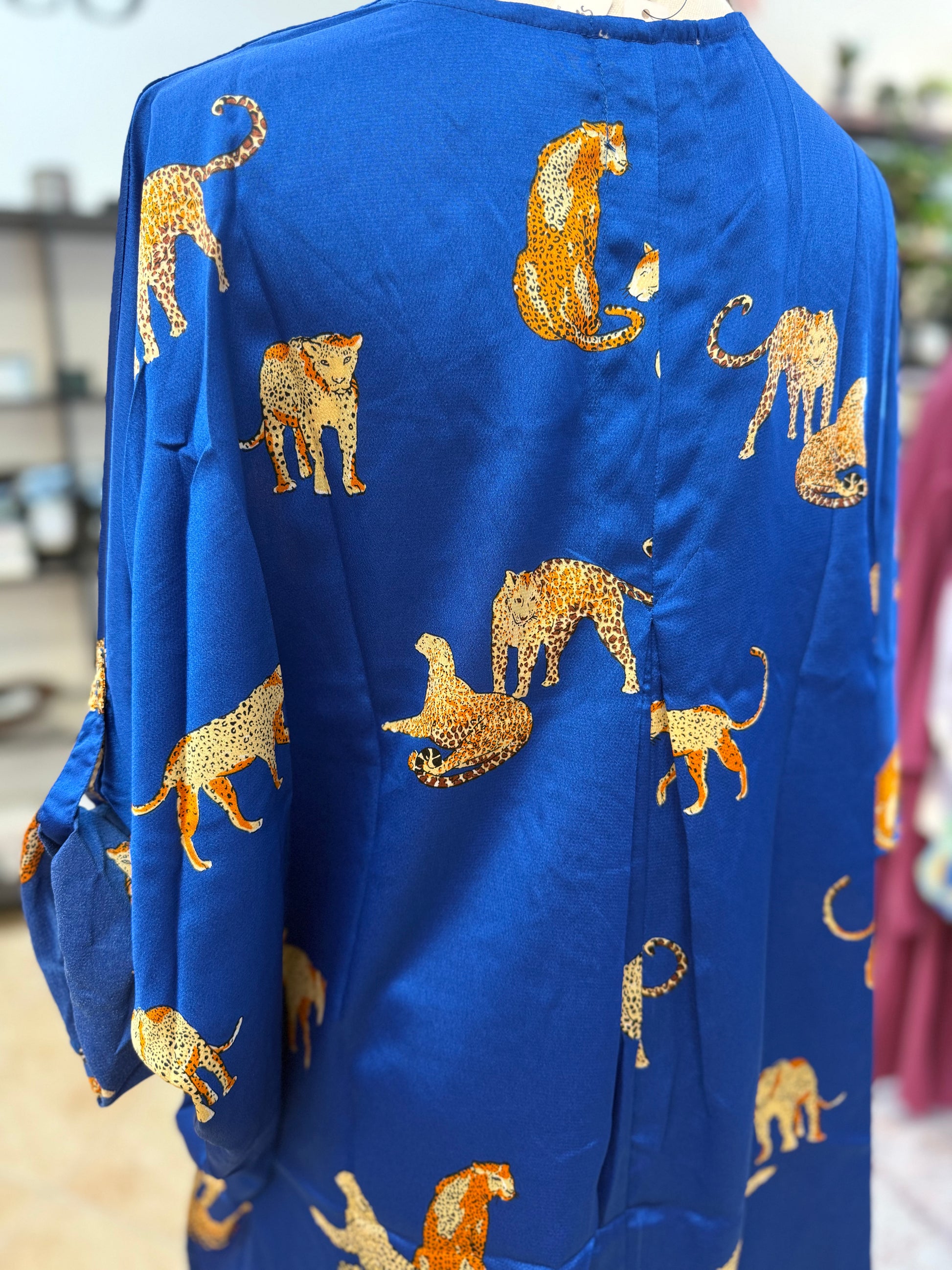 Blue garment with gold animal patterns on a blurred background