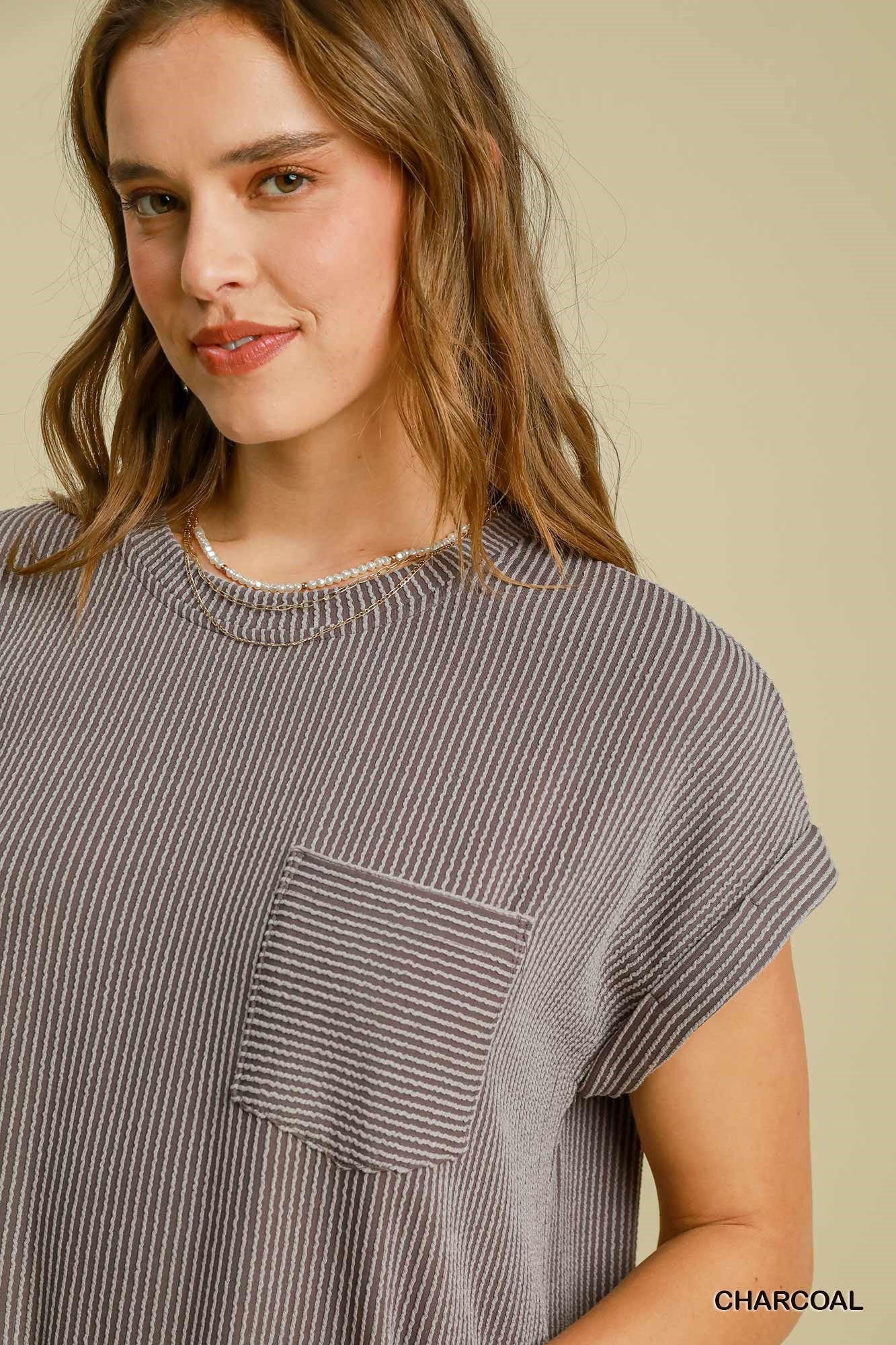 Woman wearing a striped dress with a pocket on a beige background