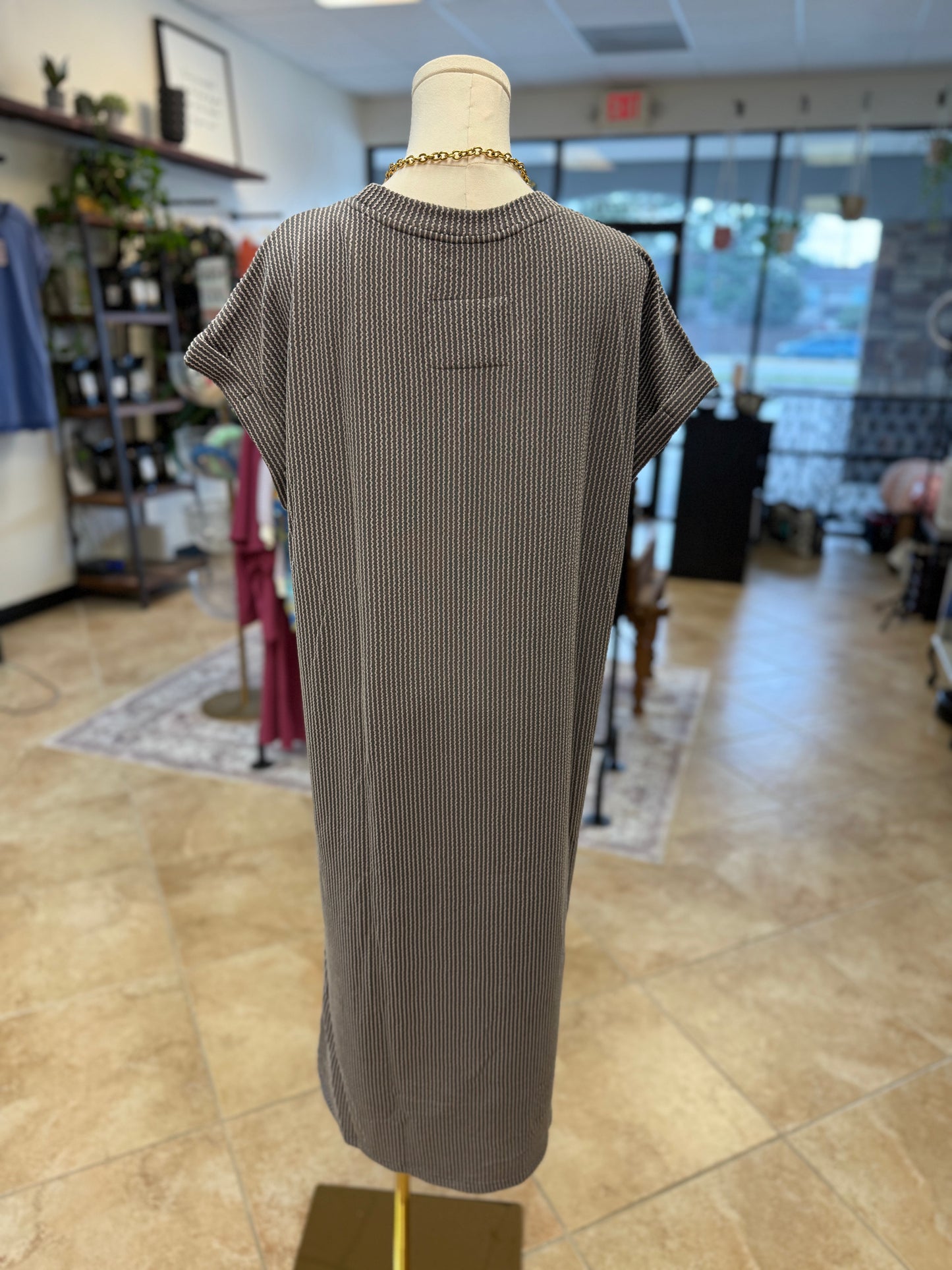 Back of grey ribbed dress on a mannequin in a store setting