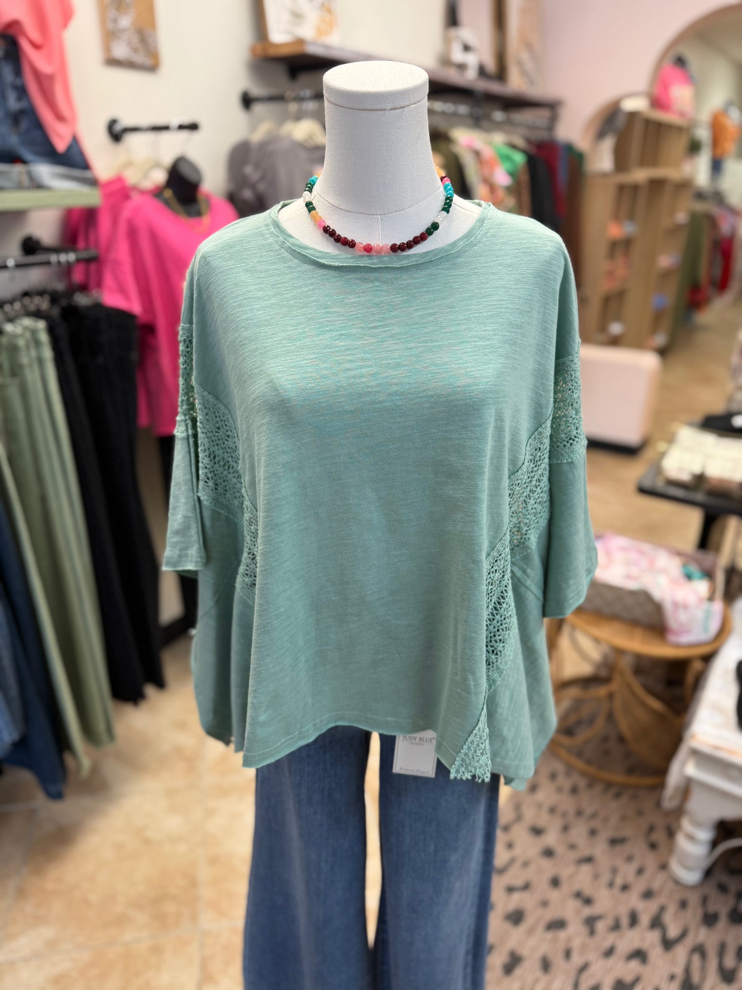 Teal Blouse with lace detail on a mannequin